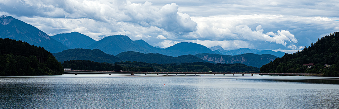 Reservoir surrounded by mountains and clouds